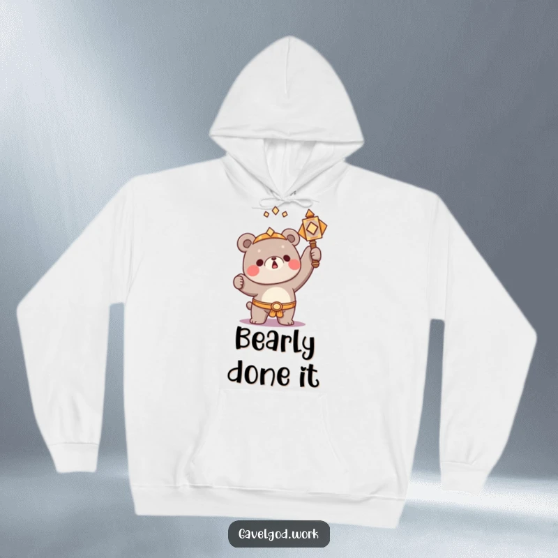 Funny Kawaii bear character triumphantly raising a small, ornate hammer, a cozy and humorous hoodie.